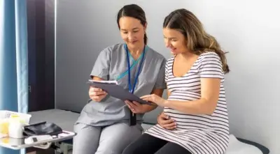 Healthcare professional reviewing information with pregnant woman