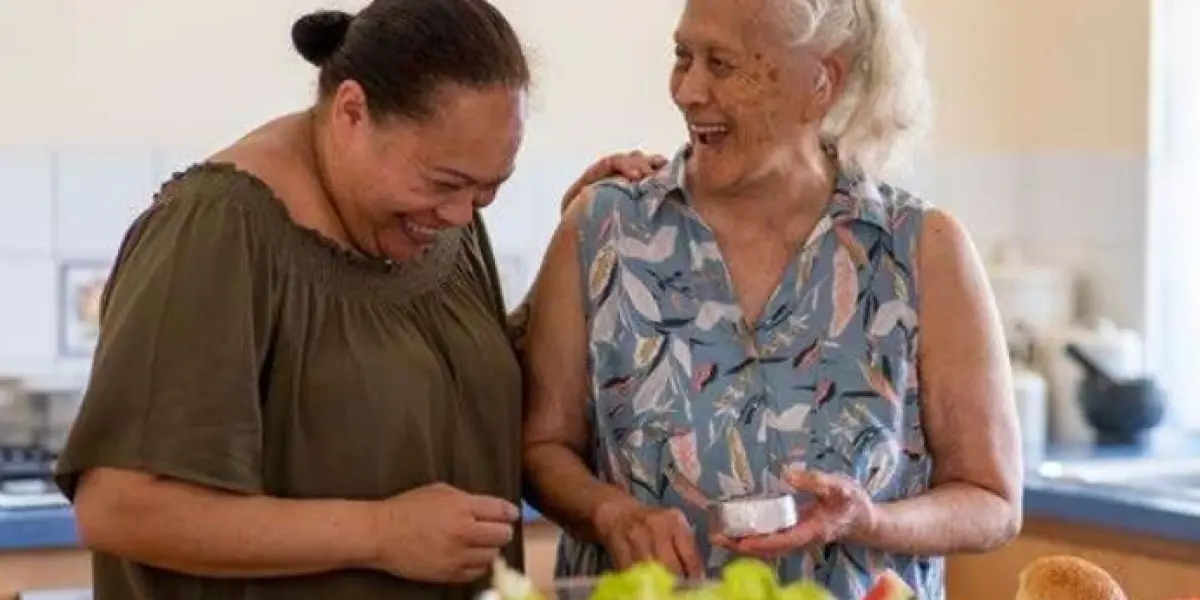 Two women preparing healthy food together in a kitchen