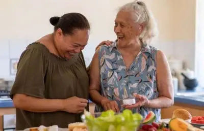 Two women preparing healthy food together in a kitchen